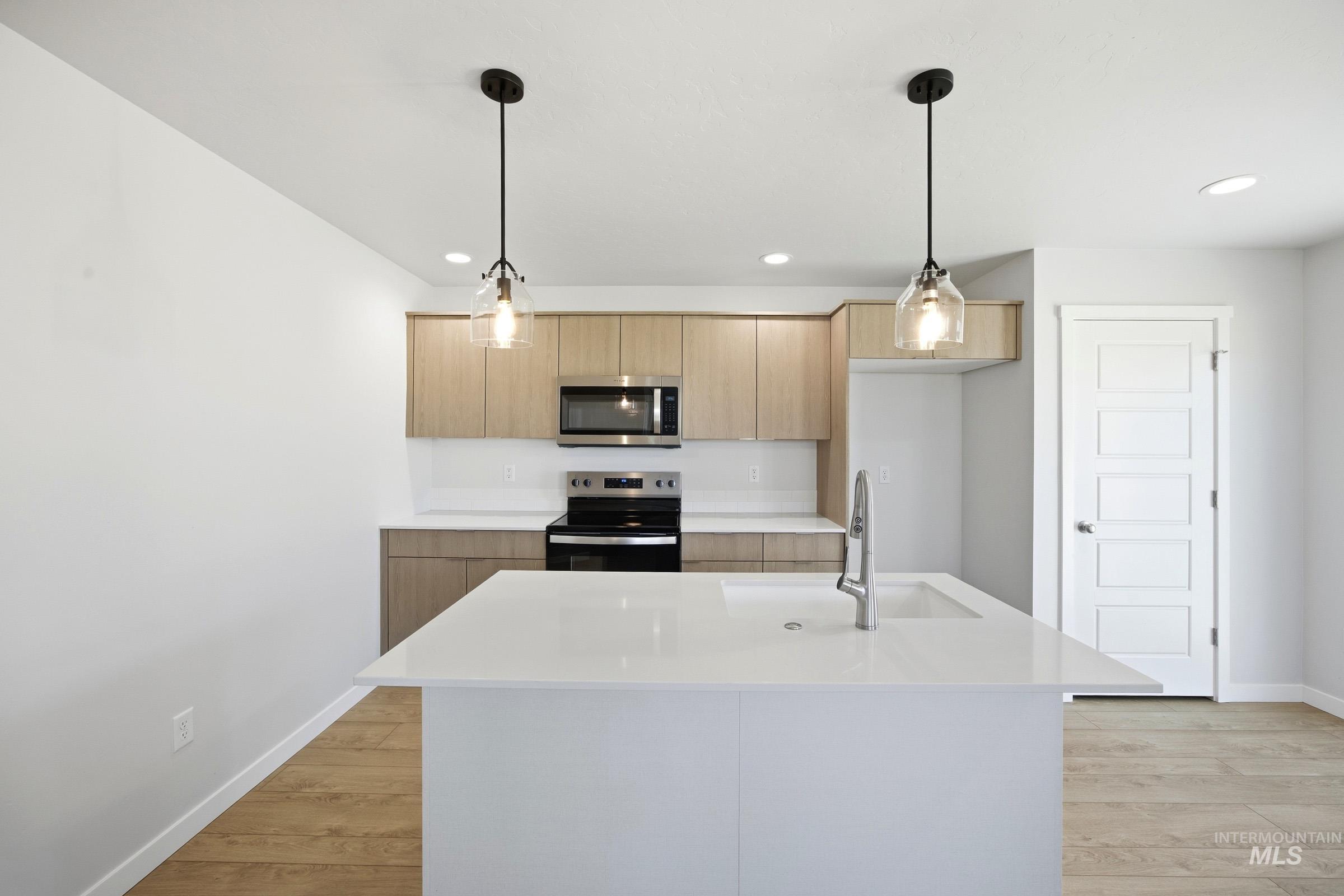 16211 Andes Avenue Caldwell, ID 83607 - Photo 3 of 22 Kitchen featuring a center island, stainless steel appliances, light wood-finish cabinetry, and recessed lighting