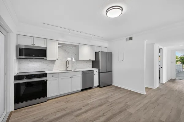 a kitchen with a refrigerator stove and microwave