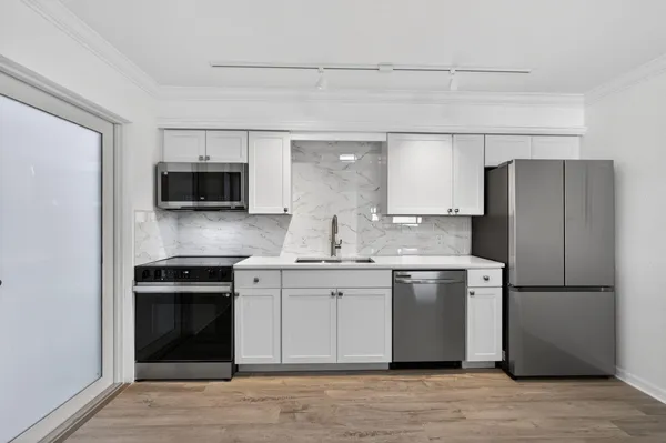 a kitchen with stainless steel appliances a refrigerator stove and microwave