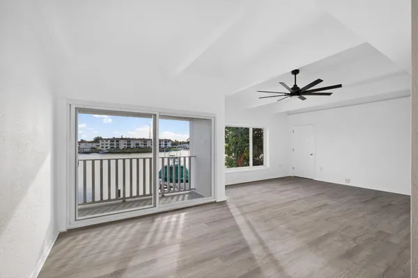a view of a livingroom with a ceiling fan and window