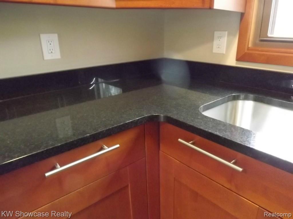 2033 Porter Road White Lake, MI 48383 - Photo 12 of 36 Elegant and gorgeous granite counters and stainless steel hardware complete this kitchen.