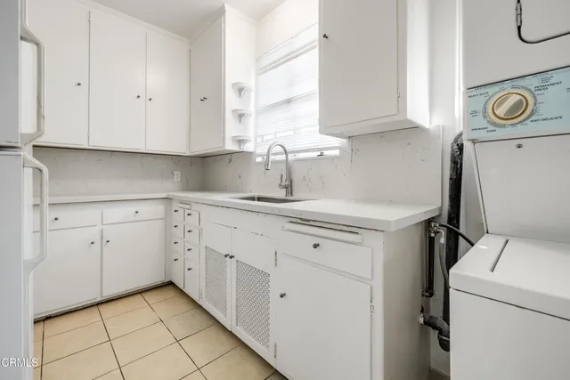 a view of a kitchen with fridge and wooden floor