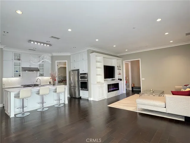 a large white kitchen with a table and chairs in it