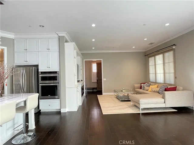 a living room with furniture and kitchen view