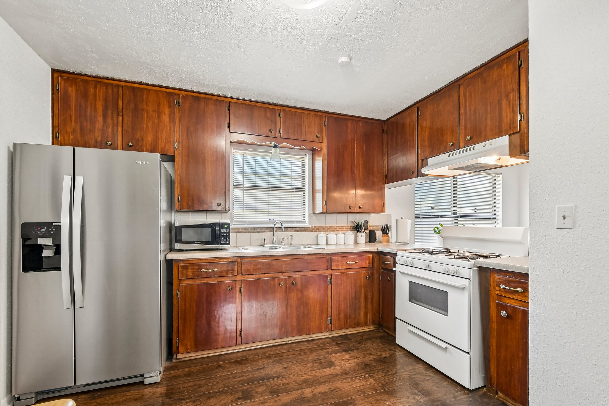 101 Brown Street Elgin, TX 78621 - Photo 10 of 32 a kitchen with a stove sink and refrigerator
