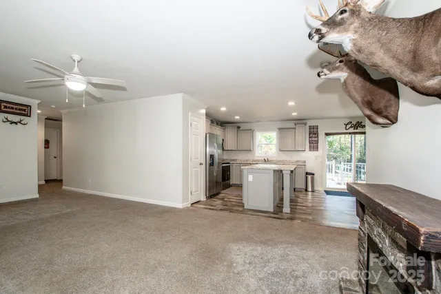 a bathroom with a granite countertop sink a toilet and a window
