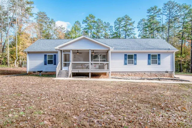 a view of a house with a yard and tree s