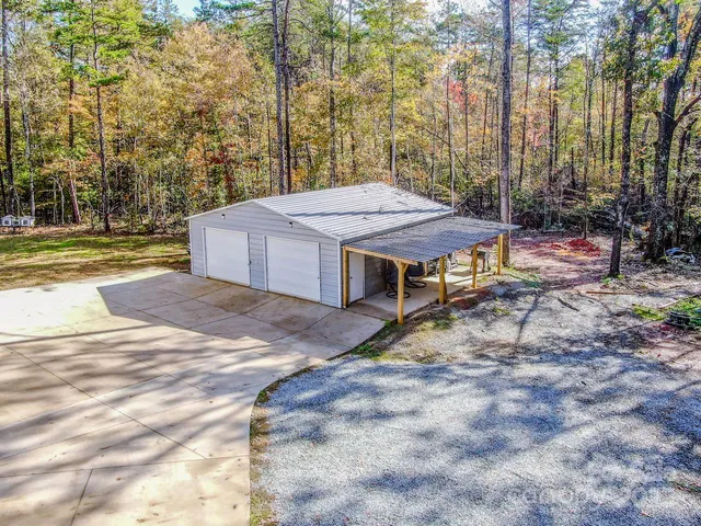 a kitchen with stainless steel appliances granite countertop a sink stove refrigerator and cabinets