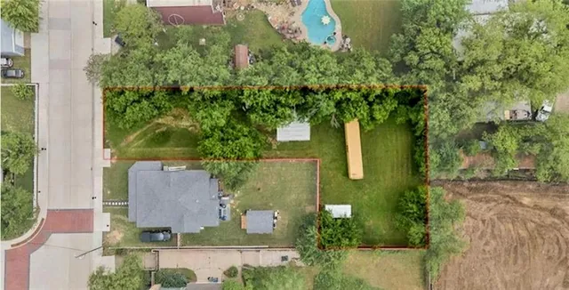 an aerial view of a house with a yard basket ball court and outdoor seating
