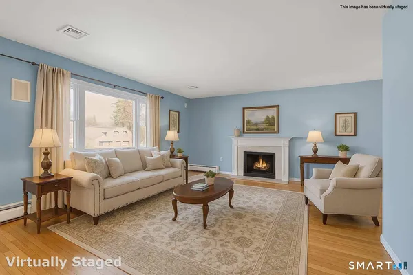 a living room with furniture a rug and a fireplace