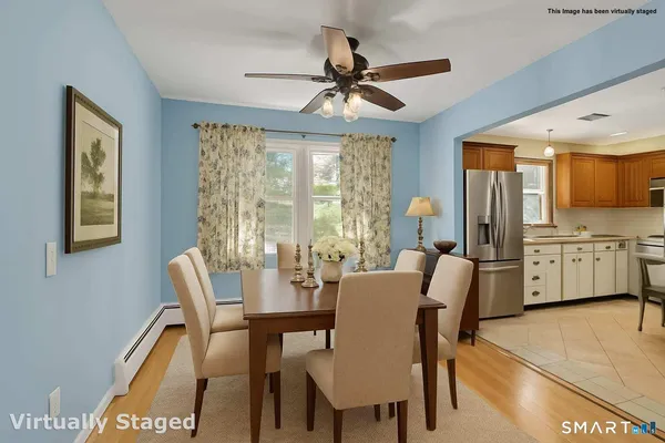 a view of a dining room with furniture and a chandelier