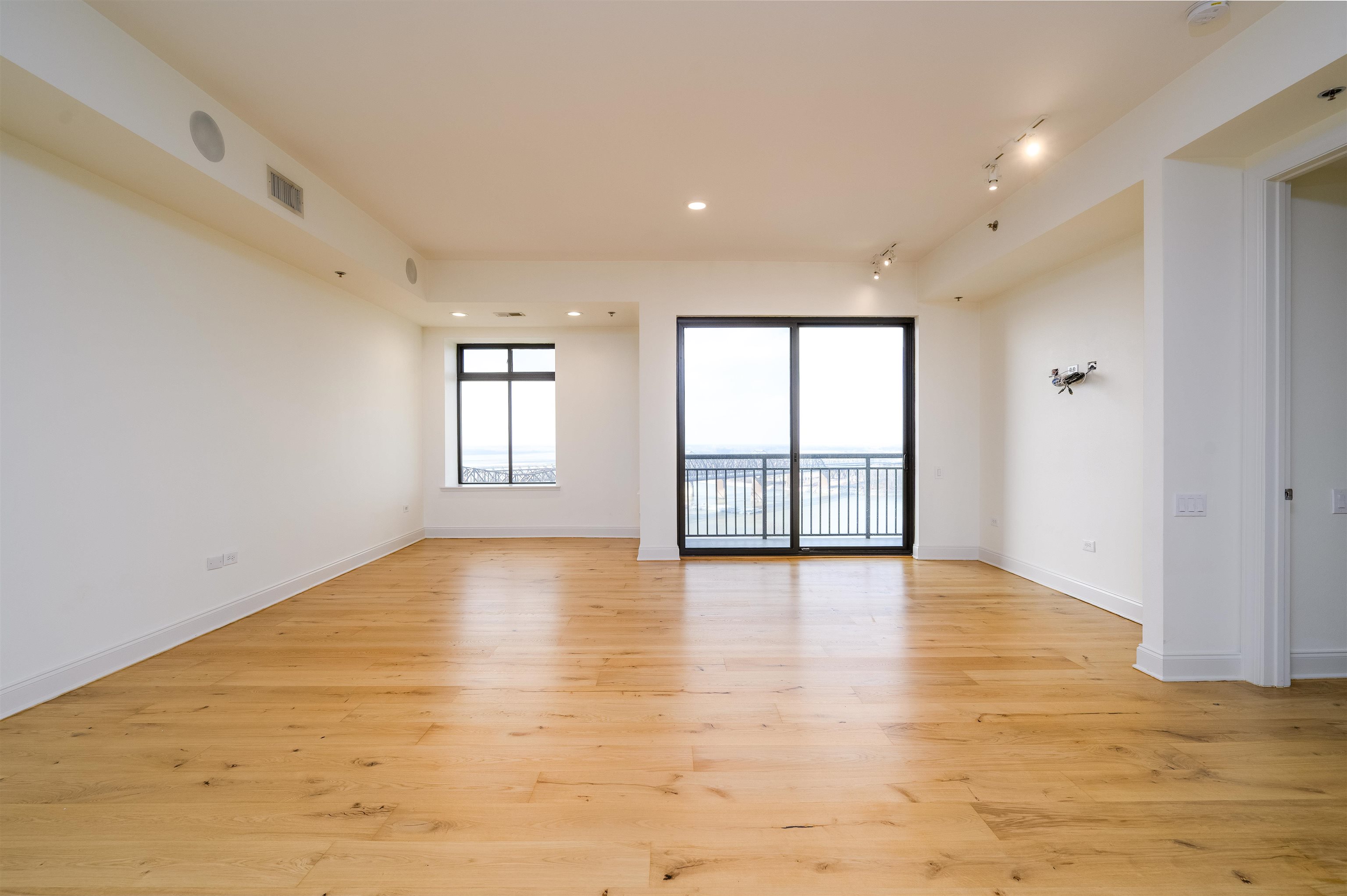 717 Riverside Drive, Unit 1506 Memphis, TN 38103 - Photo 2 of 38 a view of an empty room with window and wooden floor