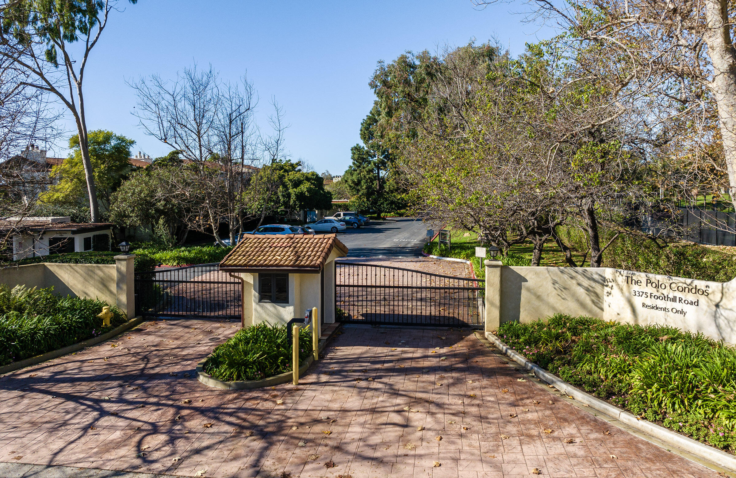 3375 Foothill Road, Unit 232 Carpinteria, CA 93013 - Photo 14 of 17 a view of a patio with table and chairs plants and large trees