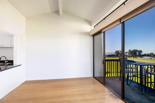 a view of a balcony with furniture and city view