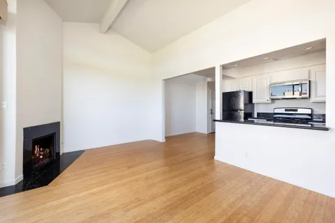 a kitchen with stainless steel appliances granite countertop a stove and a microwave