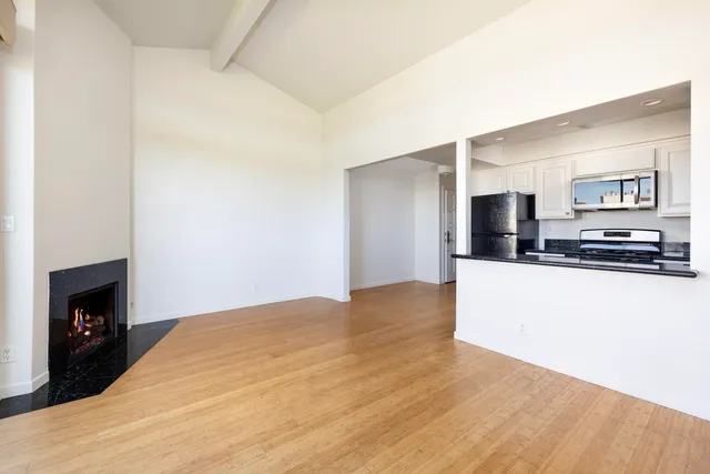 a kitchen with stainless steel appliances granite countertop a stove and a microwave