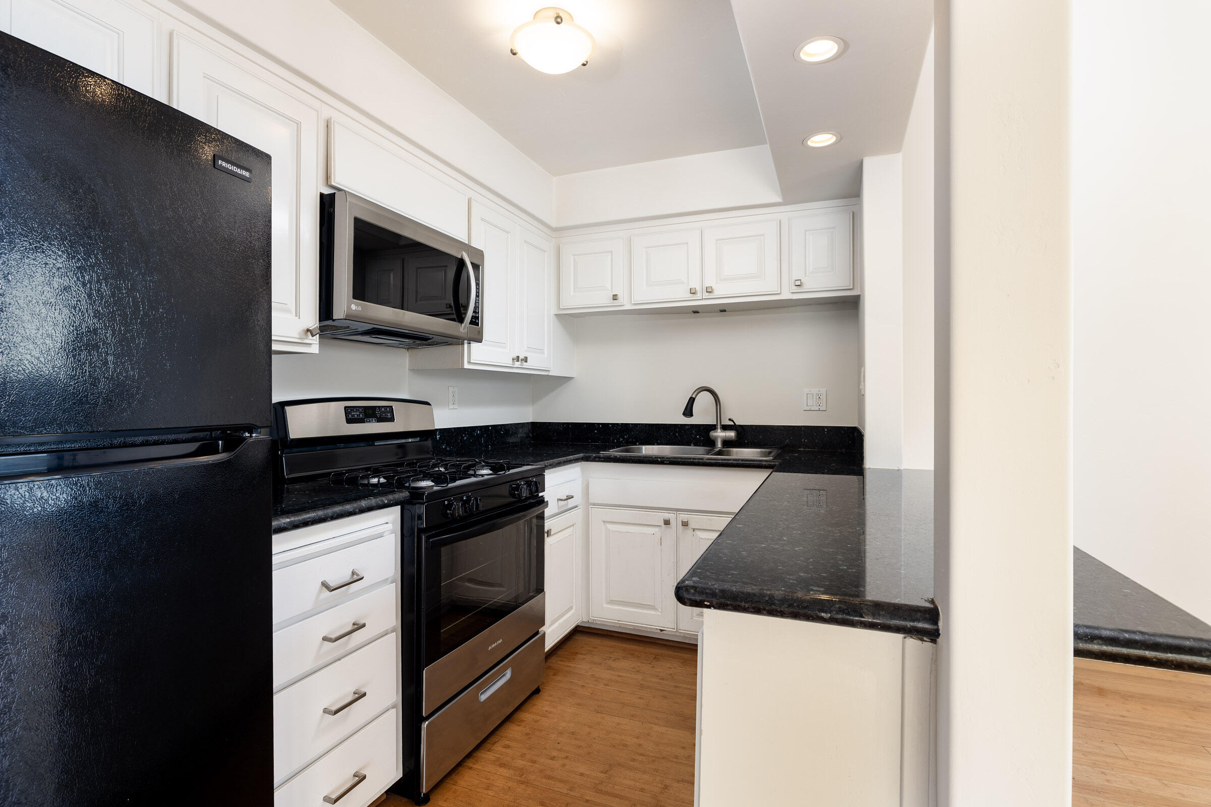 3375 Foothill Road, Unit 232 Carpinteria, CA 93013 - Photo 7 of 17 a kitchen with stainless steel appliances granite countertop a stove and a microwave