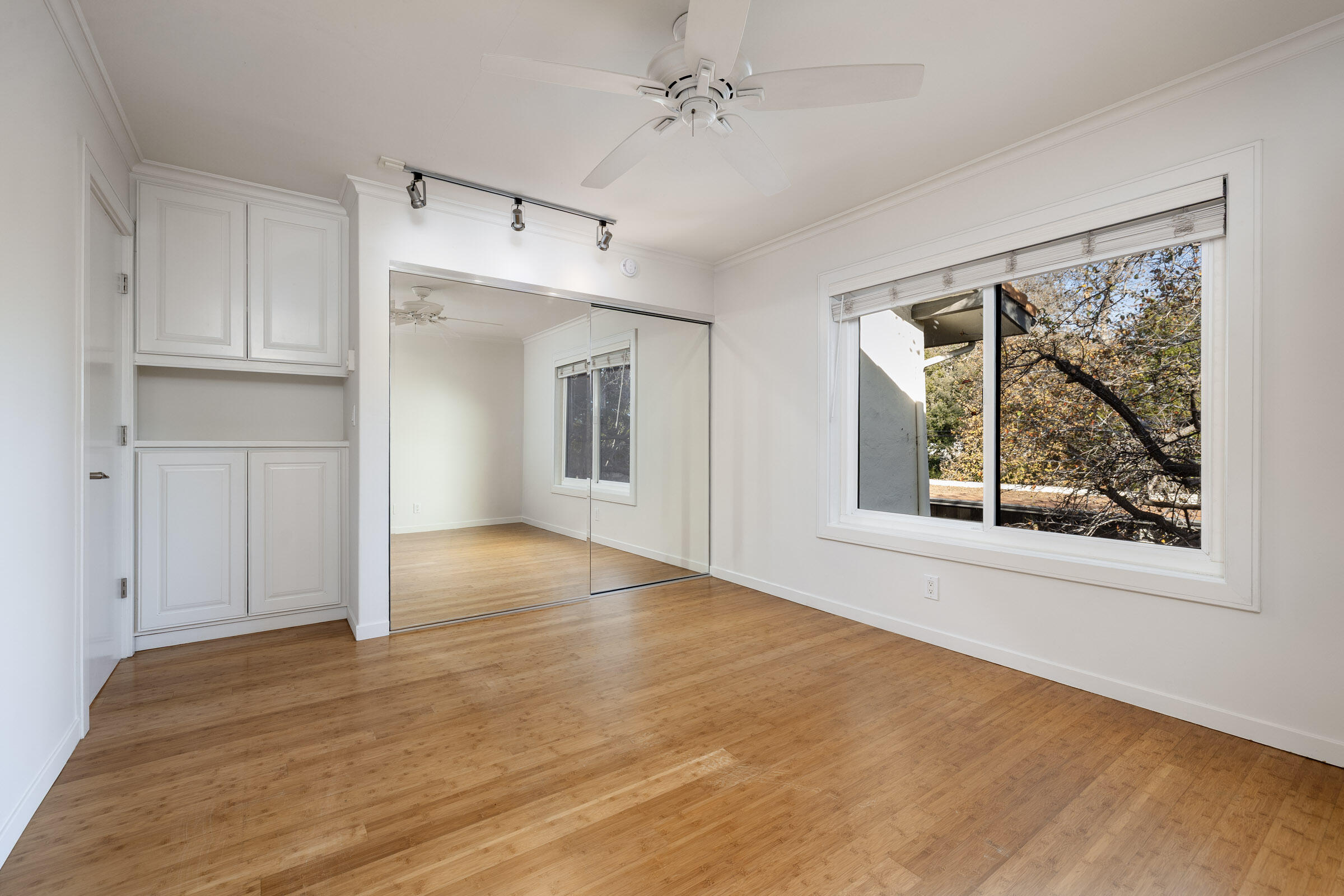 3375 Foothill Road, Unit 232 Carpinteria, CA 93013 - Photo 10 of 17 a view of an empty room with a window and wooden floor