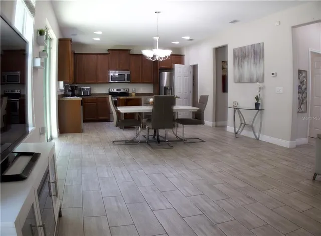 a kitchen with stainless steel appliances a refrigerator and a stove top oven