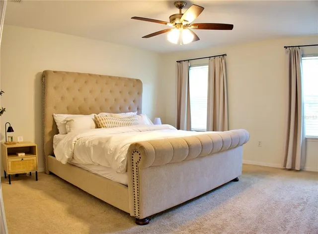 a bedroom with a bed and a chandelier