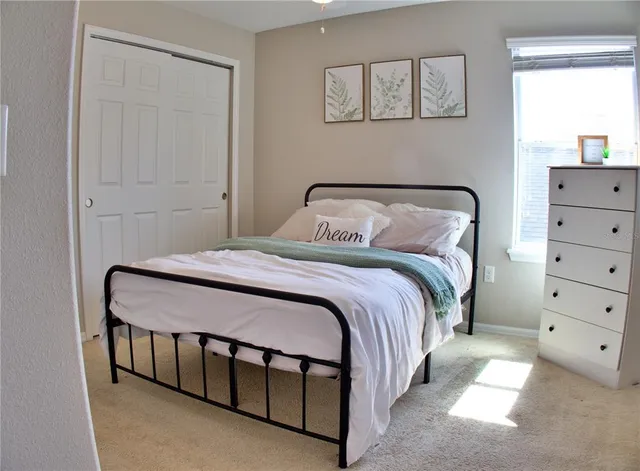 an aerial view of a house with a yard table and chairs