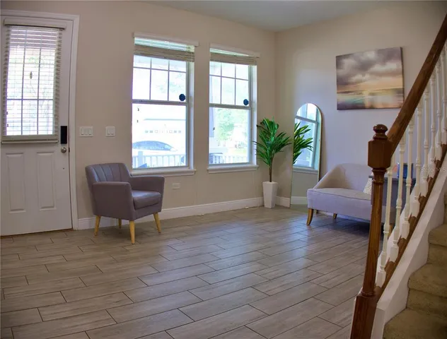 a living room with furniture and a potted plant
