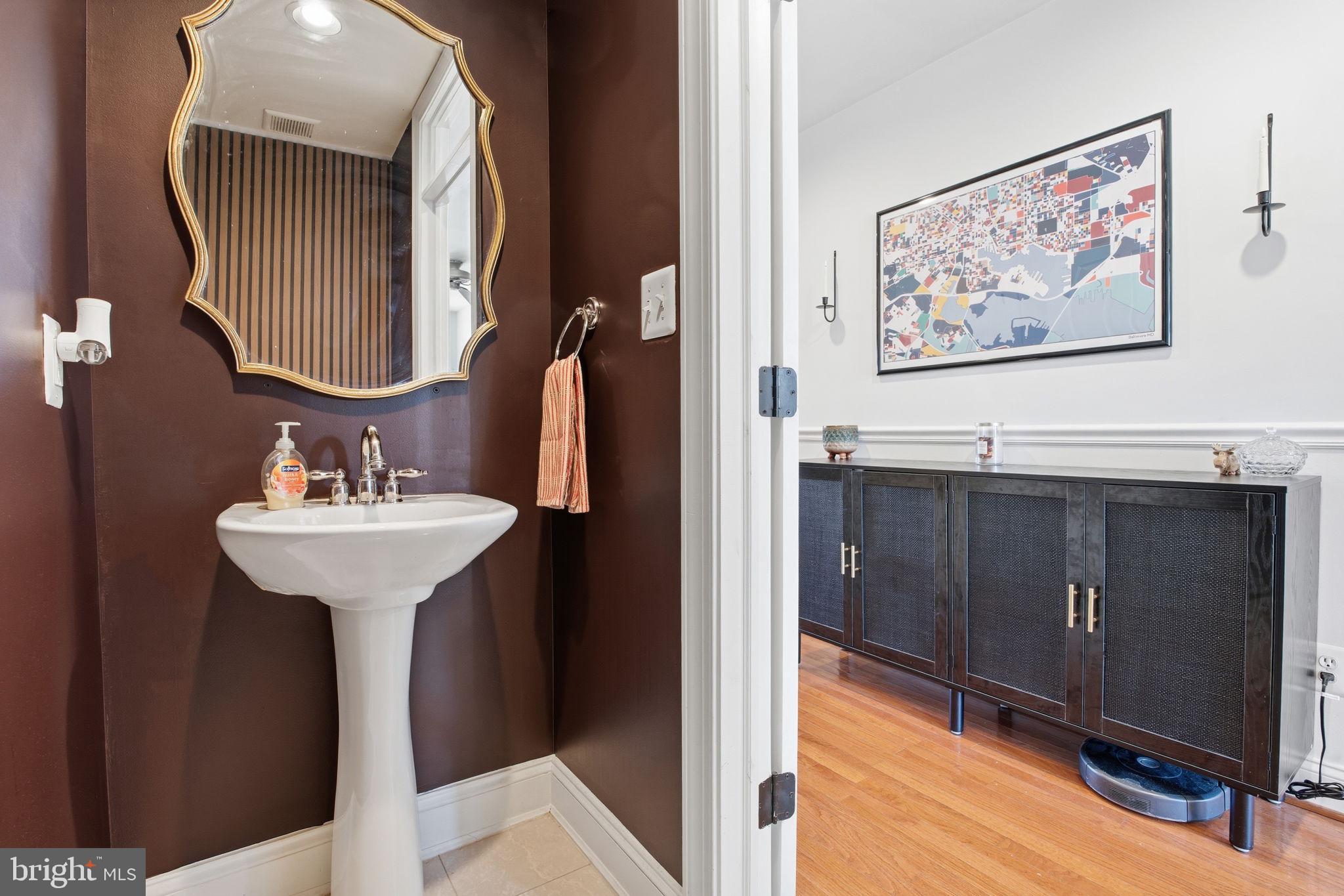 3312 Fleet Street Baltimore, MD 21224 - Photo 11 of 26 a bathroom with a sink and a mirror