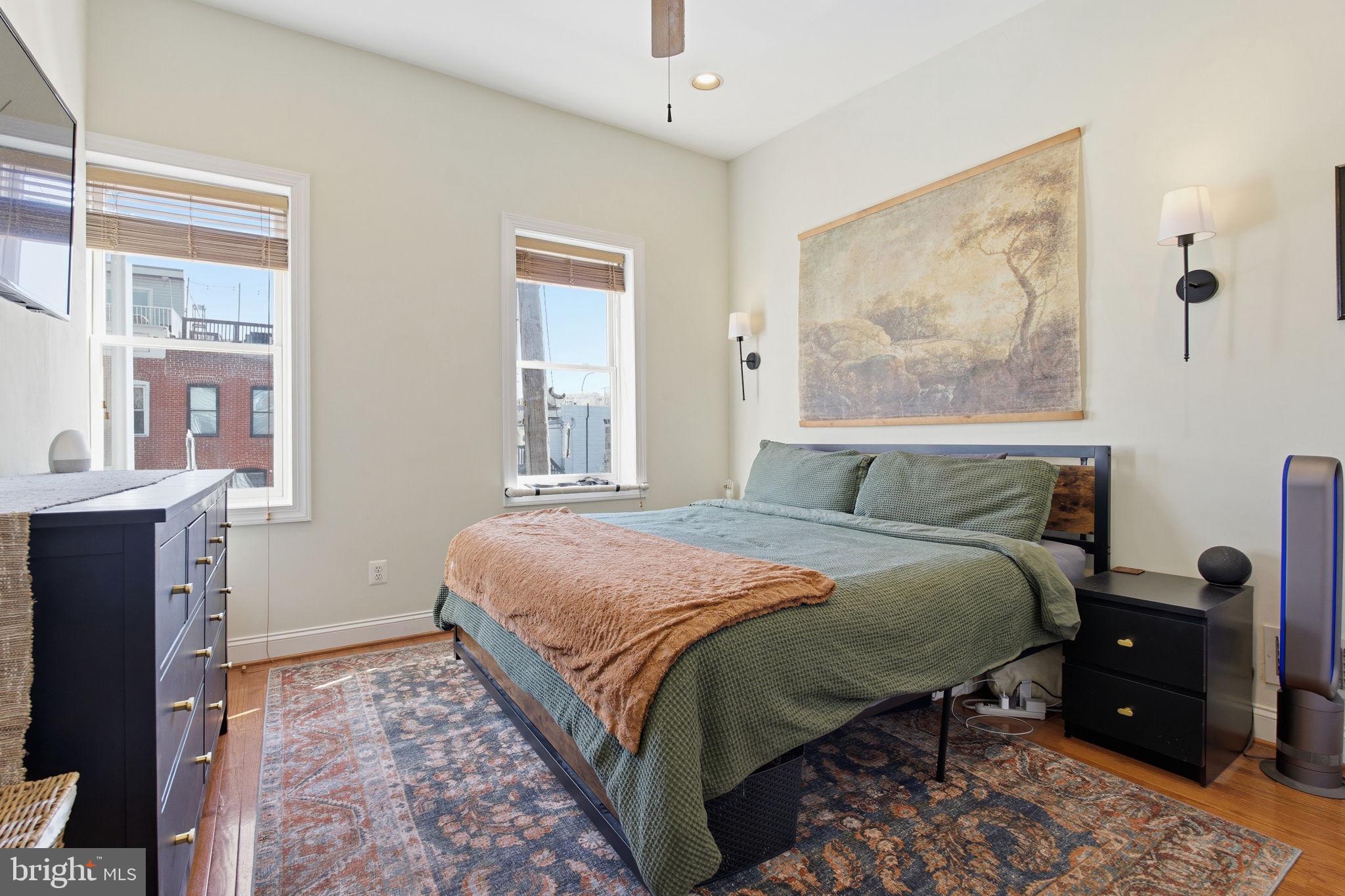 3312 Fleet Street Baltimore, MD 21224 - Photo 12 of 26 a bedroom with a bed and wooden floor