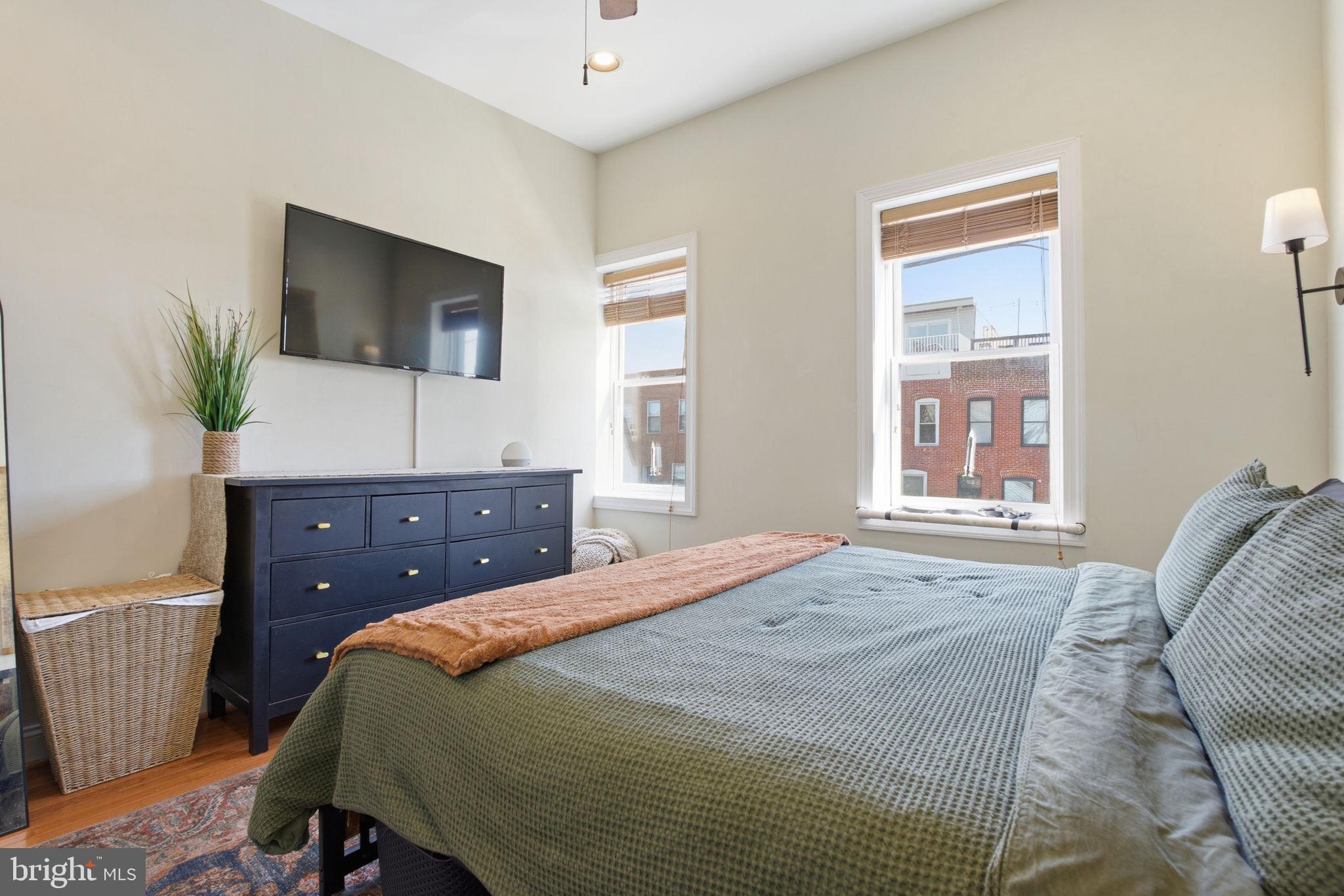 3312 Fleet Street Baltimore, MD 21224 - Photo 13 of 26 a bedroom with a bed and a dresser
