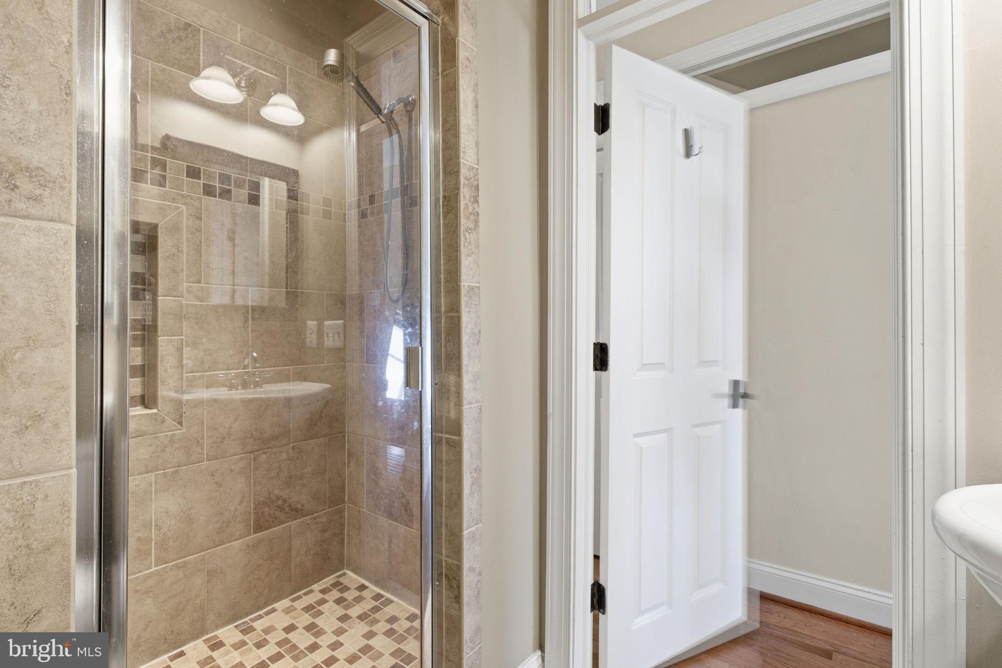 3312 Fleet Street Baltimore, MD 21224 - Photo 15 of 26 a bathroom with a glass shower door