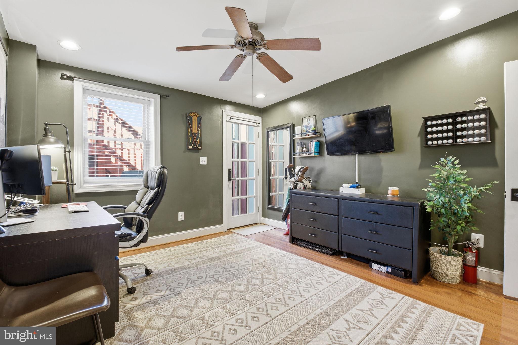 3312 Fleet Street Baltimore, MD 21224 - Photo 18 of 26 a bed room with furniture and a flat screen tv