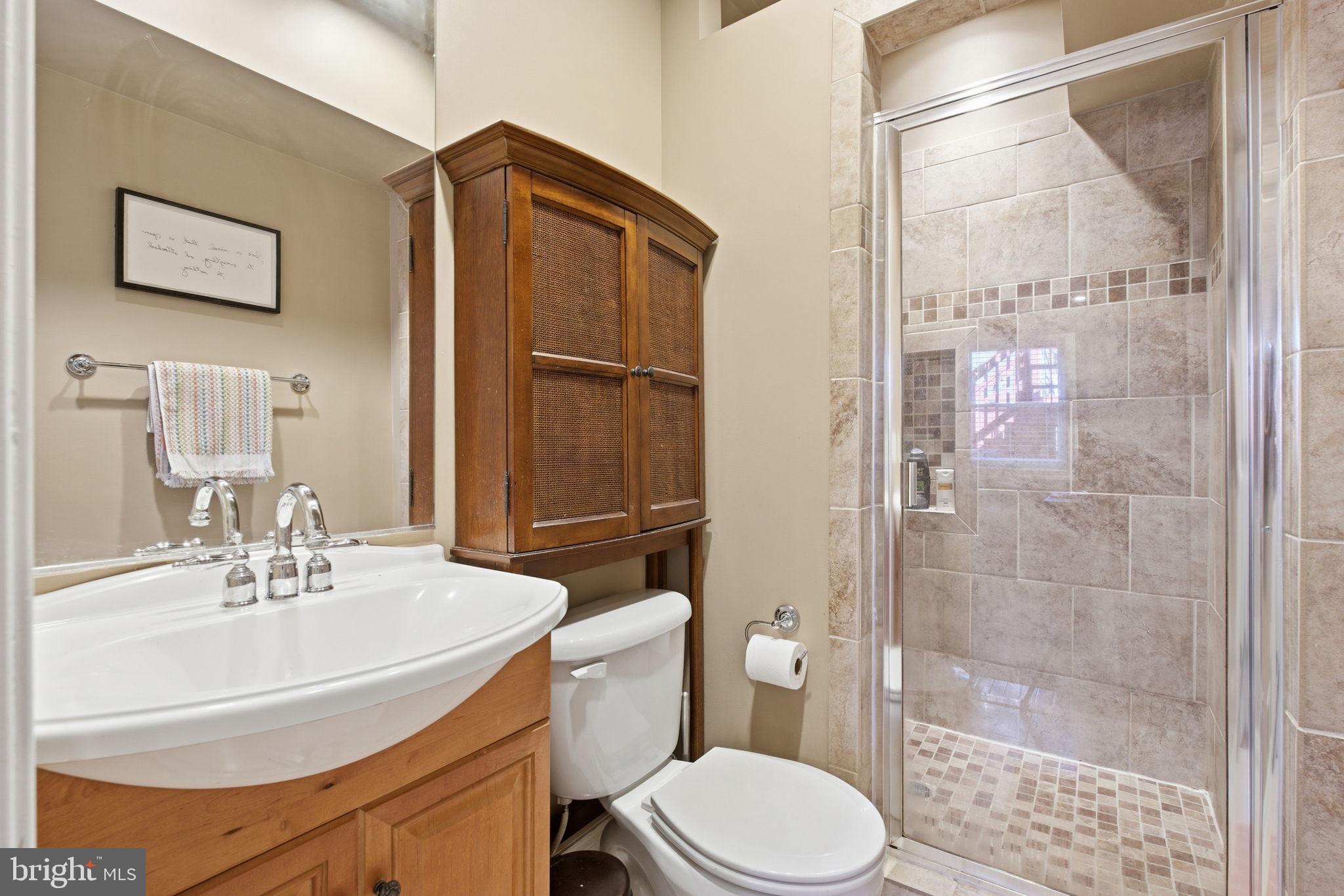 3312 Fleet Street Baltimore, MD 21224 - Photo 19 of 26 a bathroom with a sink toilet and shower