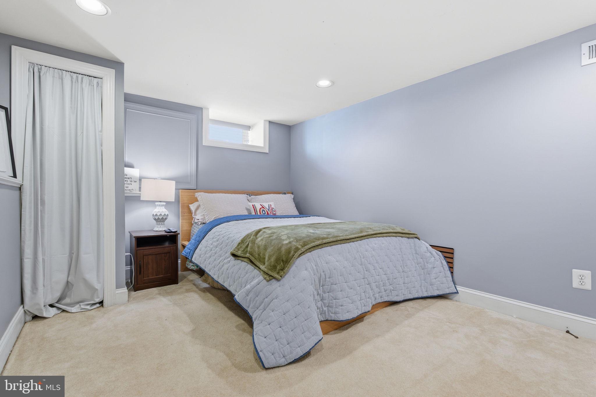 3312 Fleet Street Baltimore, MD 21224 - Photo 20 of 26 a spacious bedroom with a bed and a window