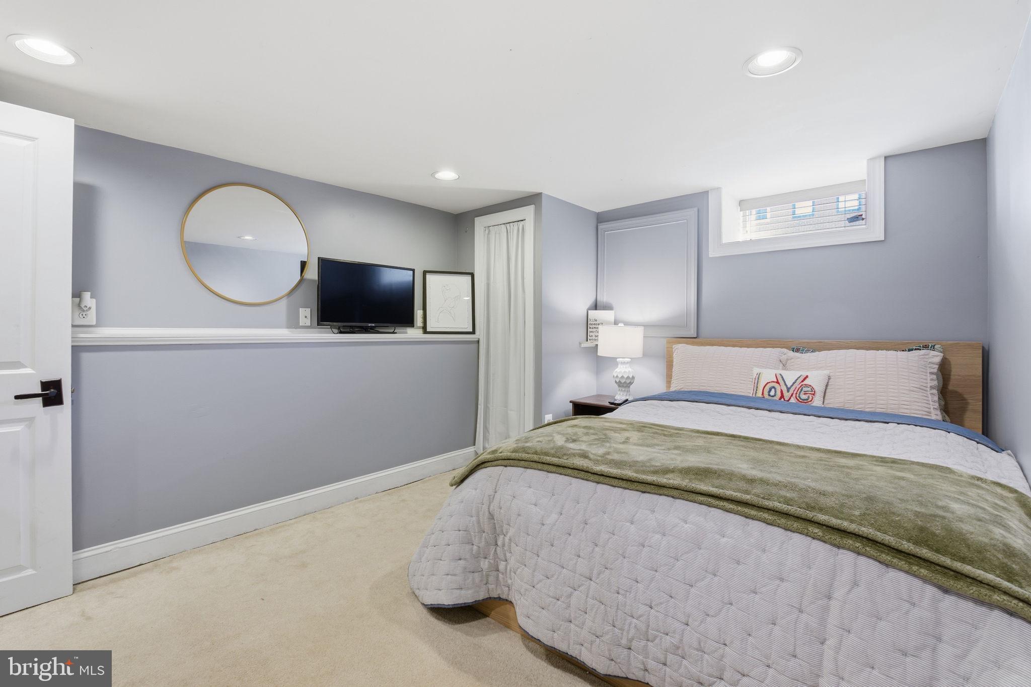 3312 Fleet Street Baltimore, MD 21224 - Photo 21 of 26 a bedroom with a bed and a flat screen tv