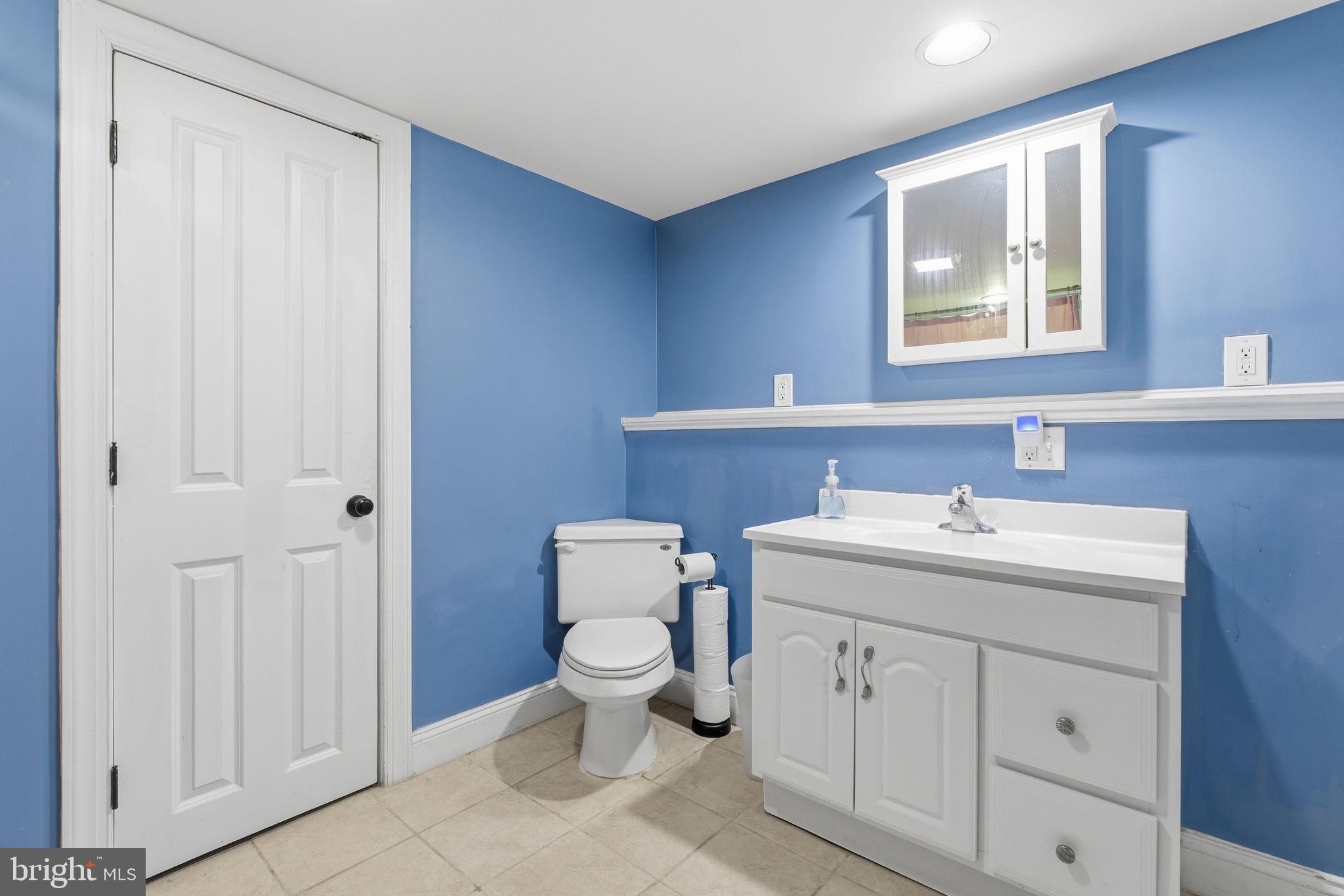 3312 Fleet Street Baltimore, MD 21224 - Photo 22 of 26 a bathroom with a toilet sink and mirror