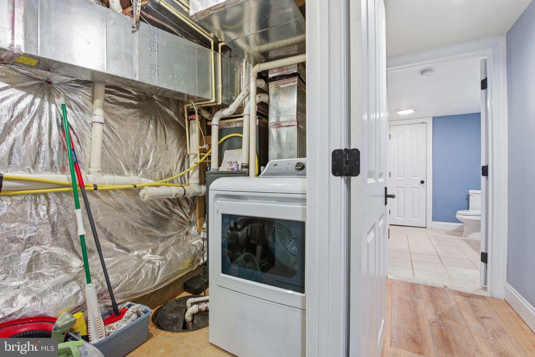 3312 Fleet Street Baltimore, MD 21224 - Photo 23 of 26 a view of walk in closet with clothes and shoes