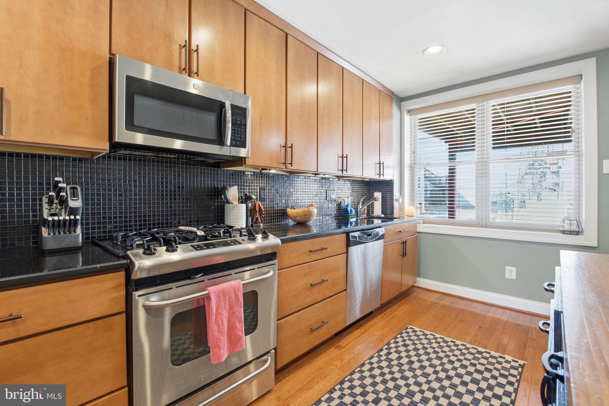 3312 Fleet Street Baltimore, MD 21224 - Photo 9 of 26 a kitchen with a stove and a microwave
