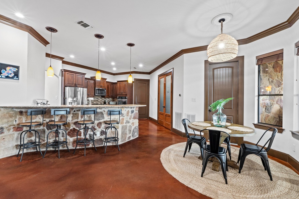 8211 Moon Rise Trail Jonestown, TX 78645 - Photo 15 of 34 Breakfast nook and countertop dining, open to the spacious family room, making for a great entertainment space.
