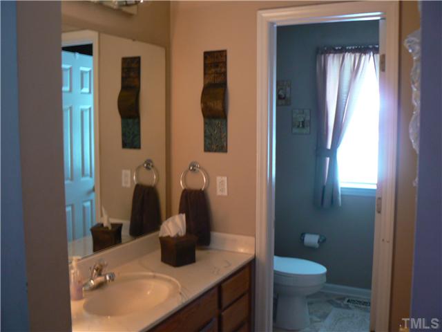 1723 Bahama Road Bahama, NC 27503 - Photo 11 of 14 a bathroom with a sink and a mirror