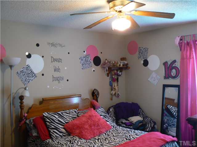 1723 Bahama Road Bahama, NC 27503 - Photo 13 of 14 a bedroom with a bed and a chandelier