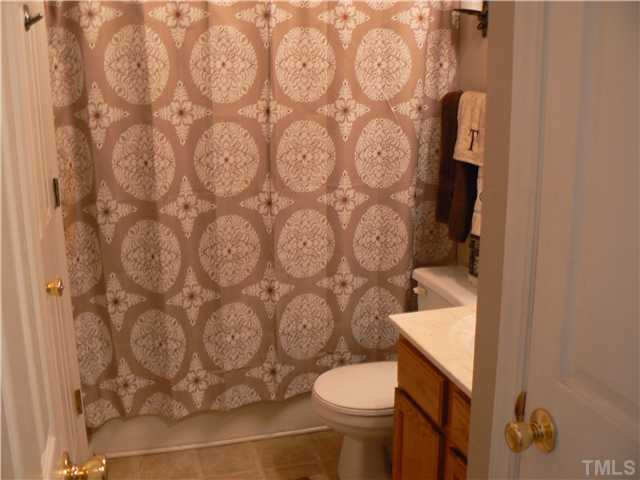 1723 Bahama Road Bahama, NC 27503 - Photo 14 of 14 a white toilet sitting next to a shower curtain