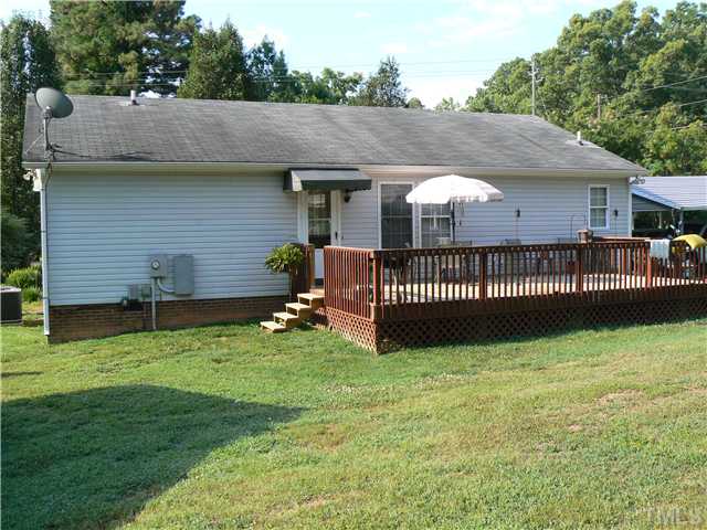 1723 Bahama Road Bahama, NC 27503 - Photo 3 of 14 a view of a house with a yard plants and large tree