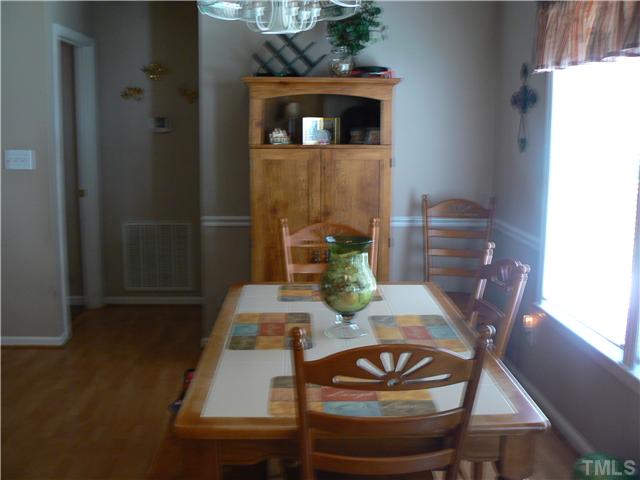 1723 Bahama Road Bahama, NC 27503 - Photo 8 of 14 a view of a dining room with furniture and wooden floor
