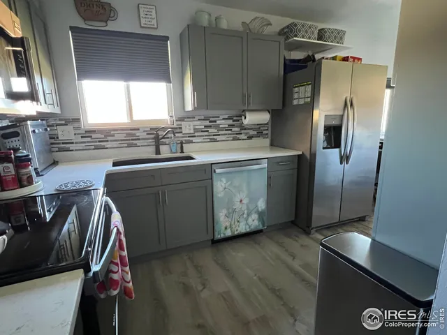 a kitchen with stainless steel appliances a sink cabinets and a counter top space