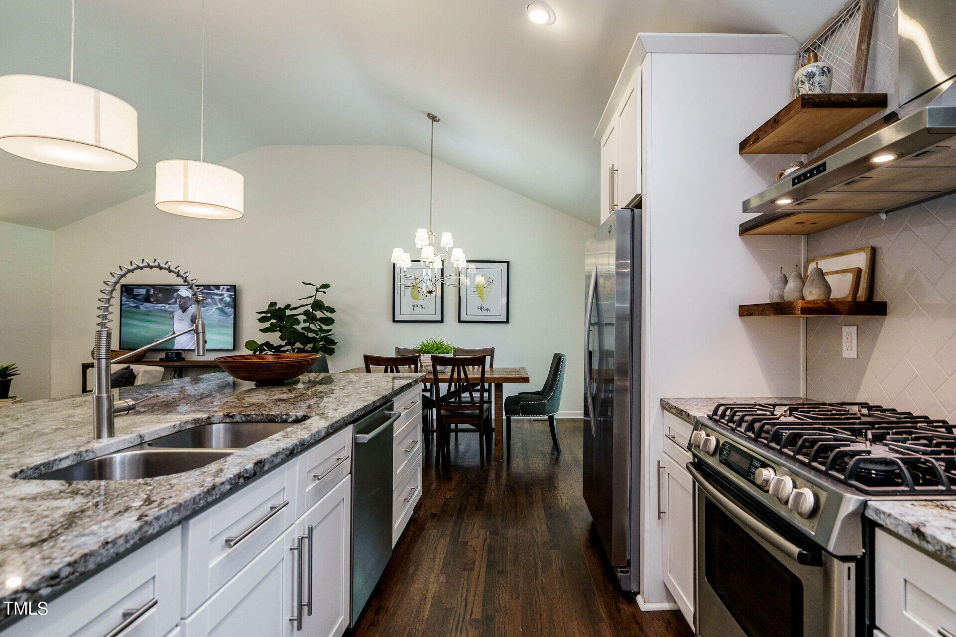 318 Glen Valley Road Raleigh, NC 27609 - Photo 11 of 39 a kitchen with stainless steel appliances granite countertop a sink a stove and a wooden floors