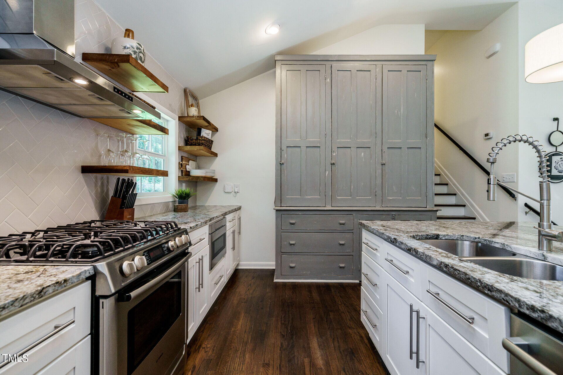 318 Glen Valley Road Raleigh, NC 27609 - Photo 12 of 39 a kitchen with granite countertop a sink stove and cabinets