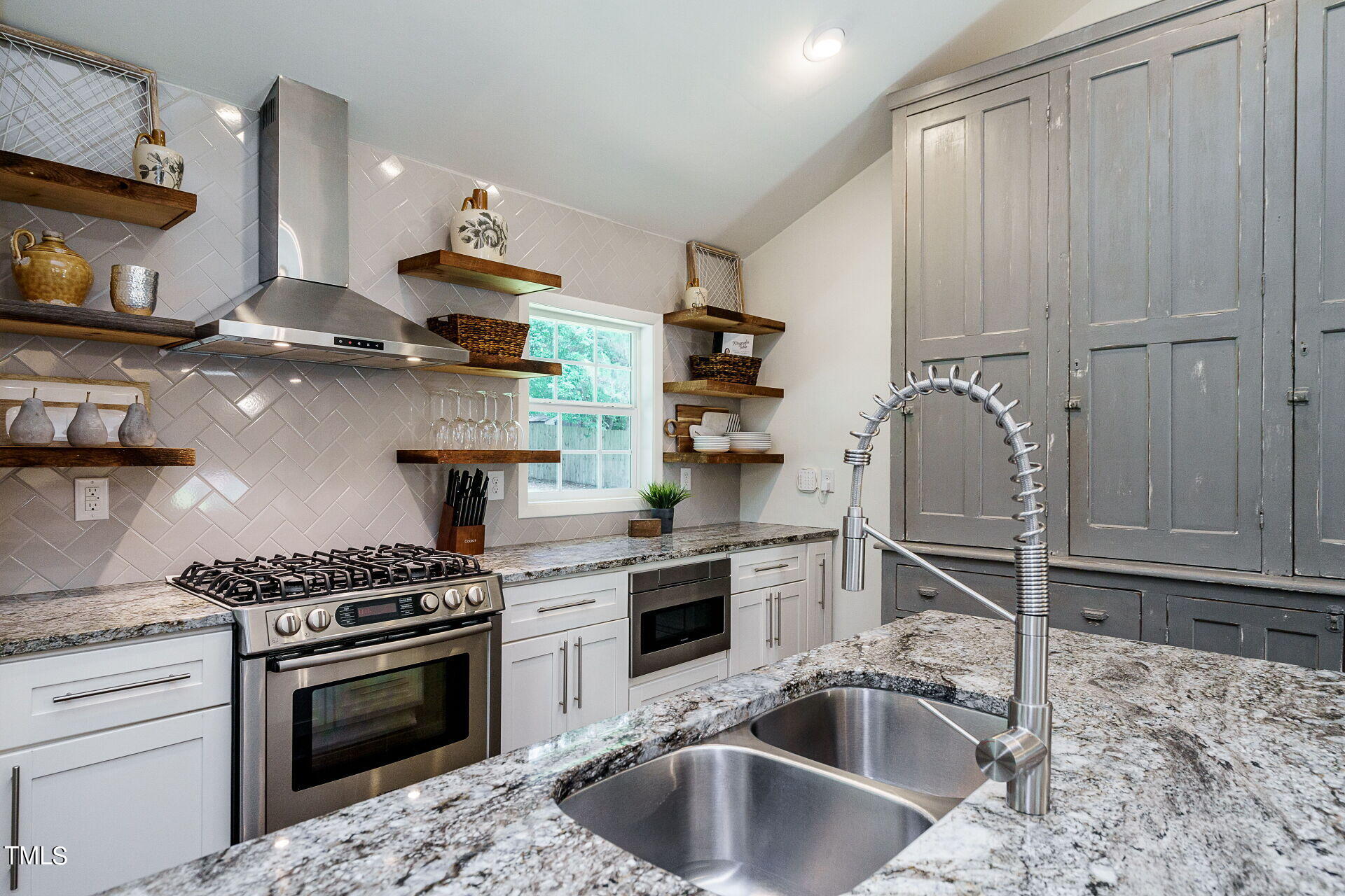 318 Glen Valley Road Raleigh, NC 27609 - Photo 13 of 39 a kitchen with stainless steel appliances granite countertop a sink stove and refrigerator