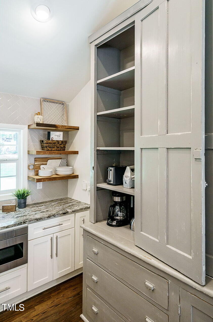 318 Glen Valley Road Raleigh, NC 27609 - Photo 16 of 39 a kitchen with appliances cabinets and a counter space