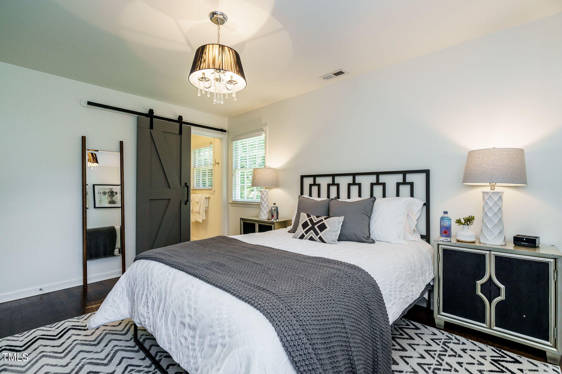 318 Glen Valley Road Raleigh, NC 27609 - Photo 27 of 39 a bedroom with a bed and a chandelier