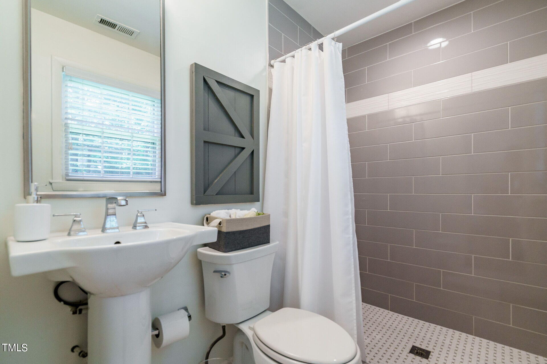 318 Glen Valley Road Raleigh, NC 27609 - Photo 29 of 39 a bathroom with a sink toilet and shower